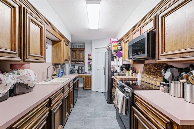 6906 Whalen Dr, Corpus Christi, TX 78413 - kitchen featuring stainless steel microwave, electric range, light countertops, and stone finish flooring