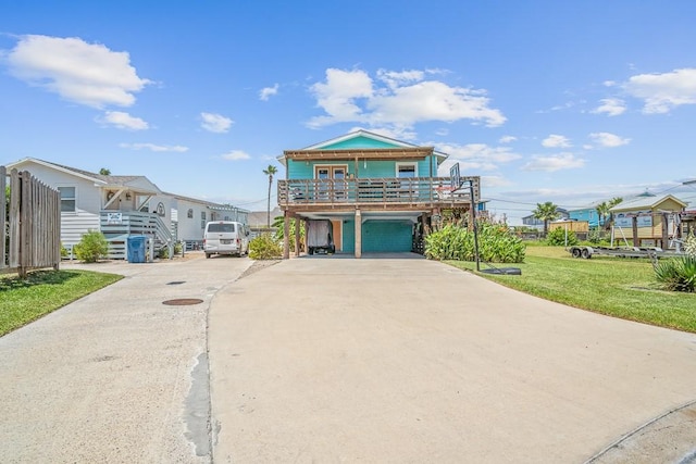1030 Tenth St S, Port Aransas, TX 78373 - coastal inspired home featuring driveway, a carport, an attached garage, a residential view, and a front yard