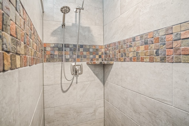 interior details featuring a tile shower