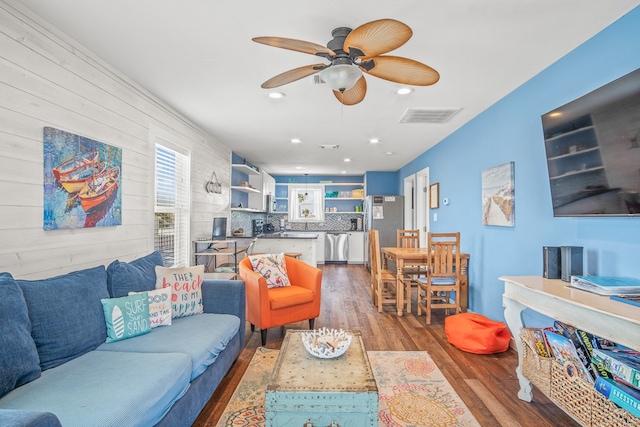 living room featuring hardwood / wood-style floors and ceiling fan