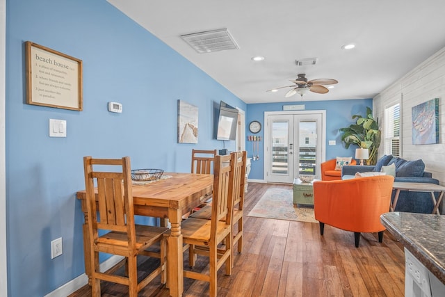 dining space with french doors, hardwood / wood-style flooring, and ceiling fan