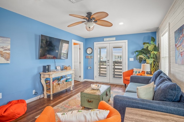 living room with french doors, plenty of natural light, and dark hardwood / wood-style flooring