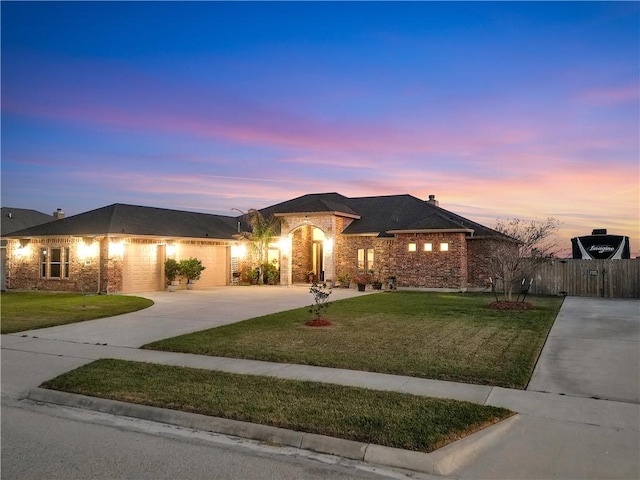 ranch-style house featuring a front yard, driveway, an attached garage, a chimney, and brick siding