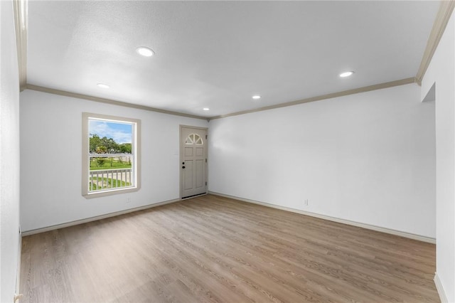 empty room featuring ornamental molding, recessed lighting, and wood finished floors