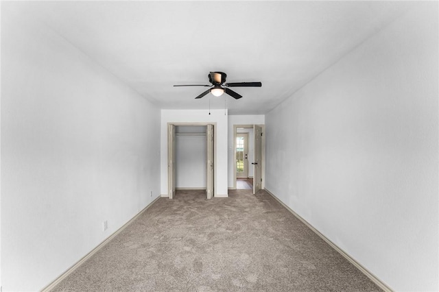 unfurnished bedroom with baseboards, a closet, ceiling fan, and carpet