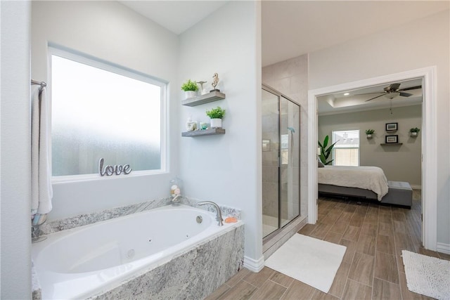 ensuite bathroom with connected bathroom, a ceiling fan, wood tiled floor, a whirlpool tub, and a stall shower