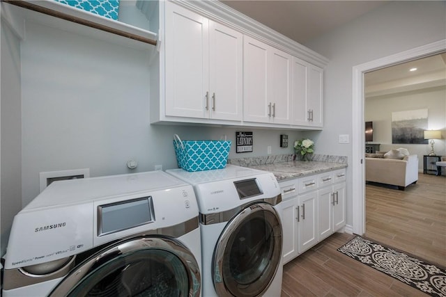 laundry room with washer and dryer, cabinet space, recessed lighting, and wood tiled floor