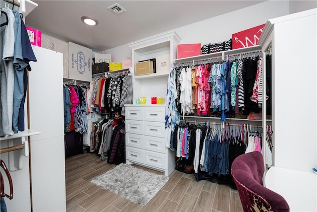 spacious closet with wood finish floors and visible vents