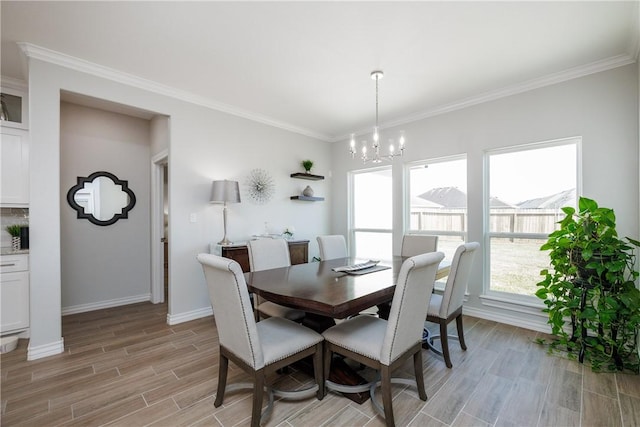 dining room featuring an inviting chandelier, plenty of natural light, crown molding, and wood finish floors