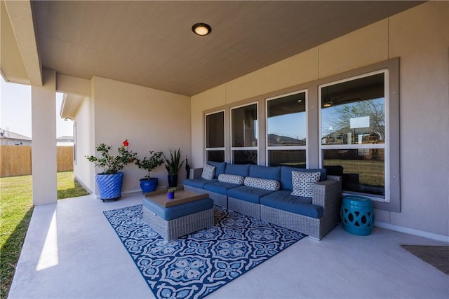 view of patio / terrace featuring outdoor lounge area and fence