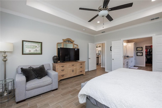 bedroom featuring visible vents, a raised ceiling, wood tiled floor, crown molding, and recessed lighting