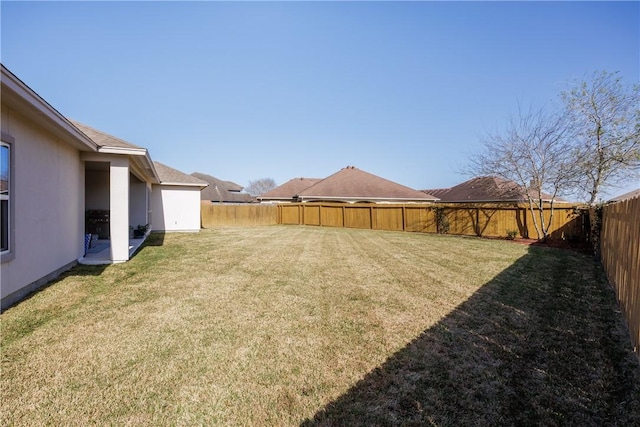 view of yard with a fenced backyard