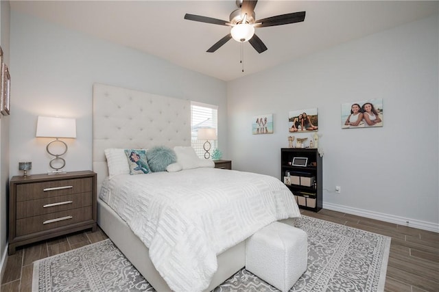 bedroom with wood finish floors, ceiling fan, and baseboards