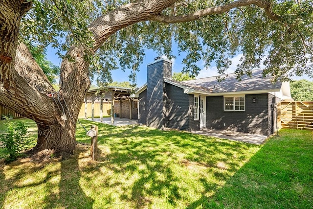 view of yard featuring fence and a patio