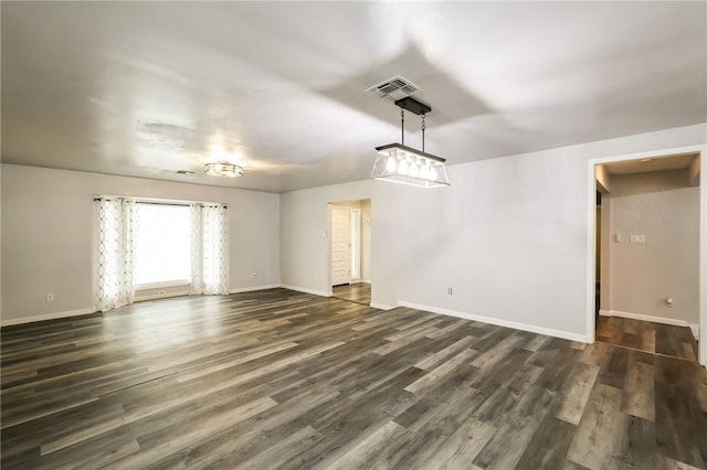 unfurnished living room featuring dark hardwood / wood-style floors