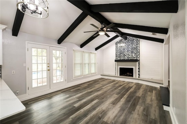 unfurnished living room featuring dark wood-type flooring, french doors, vaulted ceiling with beams, and a fireplace