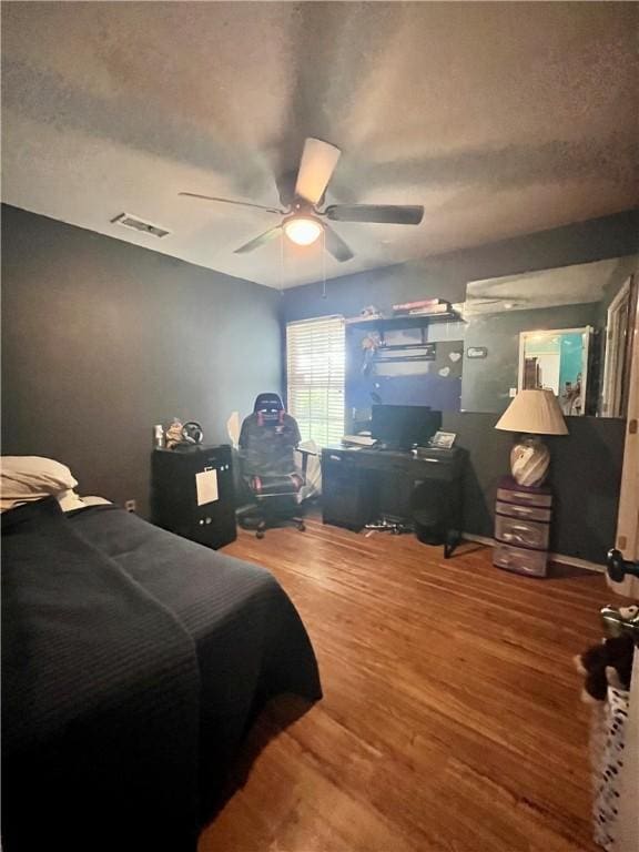 3101 Saskatchewan Dr, Corpus Christi, TX 78414 - bedroom with wood finished floors, ceiling fan, and a textured ceiling