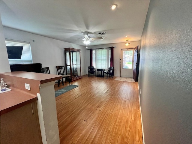 3101 Saskatchewan Dr, Corpus Christi, TX 78414 - living room with ceiling fan, light wood-style floors, and a textured wall