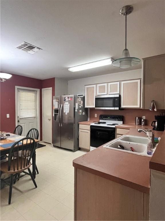 3101 Saskatchewan Dr, Corpus Christi, TX 78414 - kitchen with appliances with stainless steel finishes, light floors, and hanging light fixtures