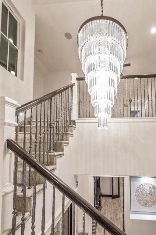 stairs featuring an inviting chandelier