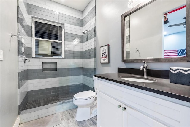 full bath with vanity, a shower stall, toilet, and wood finished floors