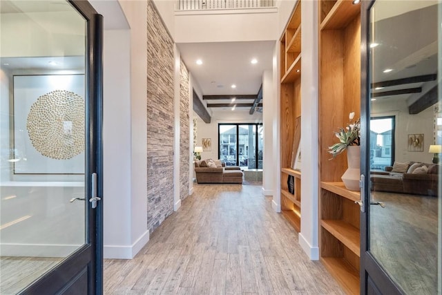 hallway featuring visible vents, recessed lighting, baseboards, and light wood-style floors