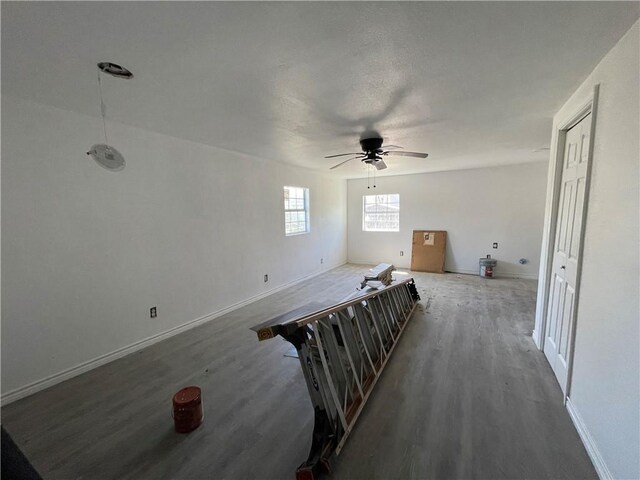 unfurnished bedroom featuring ceiling fan, baseboards, and wood finished floors