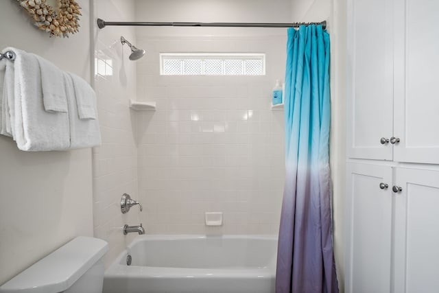 bathroom with toilet and shower / tub combo