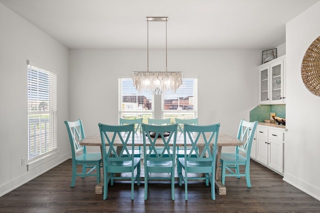 dining space with a chandelier, a healthy amount of sunlight, and dark hardwood / wood-style floors