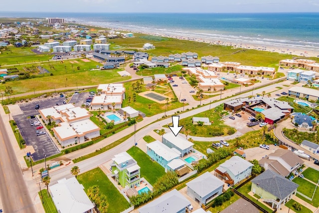 aerial view with a water view and a beach view