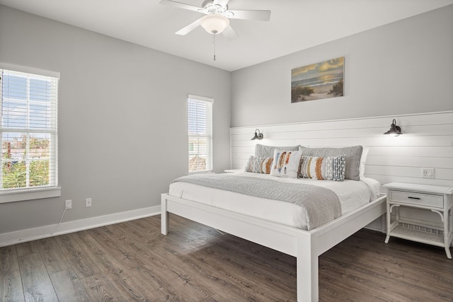 bedroom featuring multiple windows, ceiling fan, and dark hardwood / wood-style floors