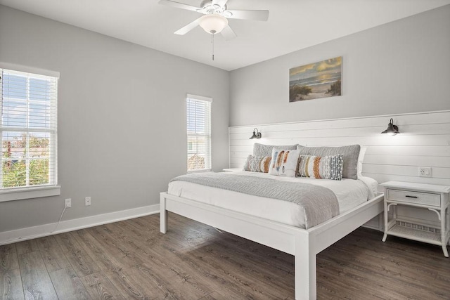 bedroom with wood finished floors, baseboards, and ceiling fan