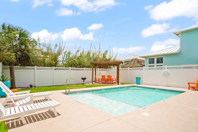 community pool with a patio, a fenced backyard, and outdoor dining space