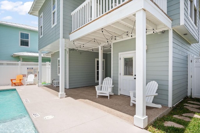 view of patio / terrace with a balcony and fence