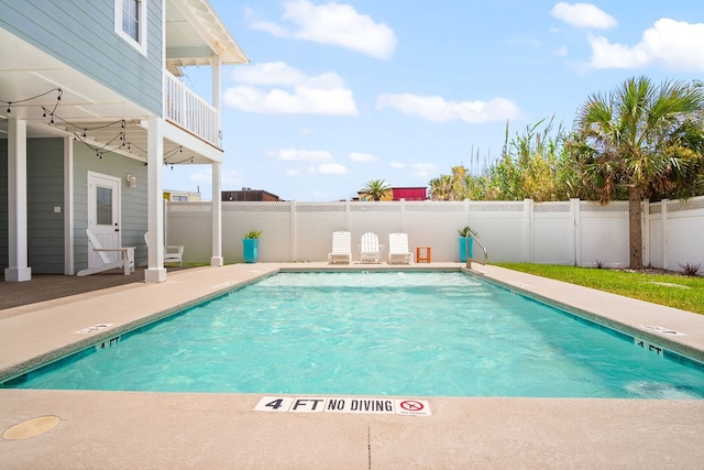 view of swimming pool with a patio