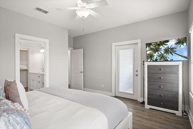 bedroom featuring access to exterior, dark wood finished floors, ceiling fan, a sink, and baseboards