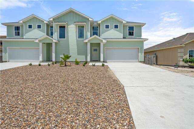 15501 Cruiser St Unit A, Corpus Christi, TX 78418 - view of front facade featuring a garage, concrete driveway, and board and batten siding