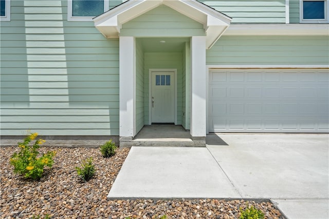 15501 Cruiser St Unit A, Corpus Christi, TX 78418 - view of exterior entry featuring a garage and concrete driveway