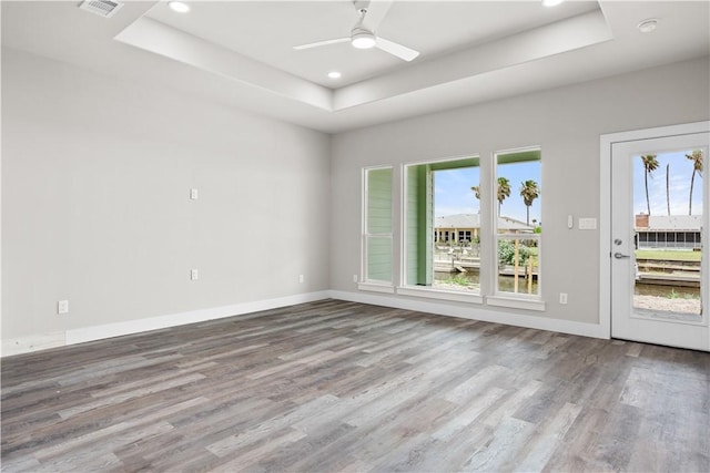 15501 Cruiser St Unit A, Corpus Christi, TX 78418 - spare room featuring a tray ceiling, wood finished floors, ceiling fan, recessed lighting, and a smoke detector