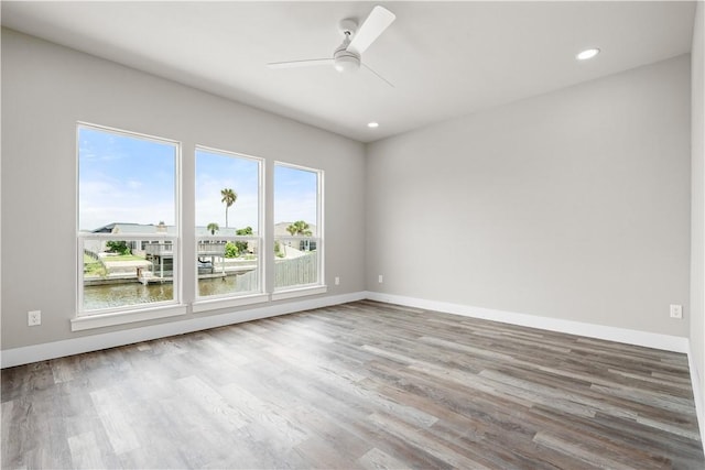 15501 Cruiser St Unit A, Corpus Christi, TX 78418 - spare room with wood finished floors, ceiling fan, recessed lighting, and a water view