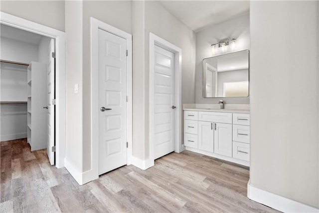 15501 Cruiser St Unit A, Corpus Christi, TX 78418 - bathroom featuring wood finished floors, vanity, and a spacious closet