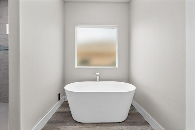 15501 Cruiser St Unit A, Corpus Christi, TX 78418 - full bath with a soaking tub and wood finished floors