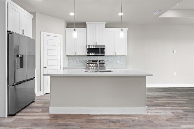 15501 Cruiser St Unit A, Corpus Christi, TX 78418 - kitchen with stainless steel appliances, light countertops, white cabinets, backsplash, and recessed lighting