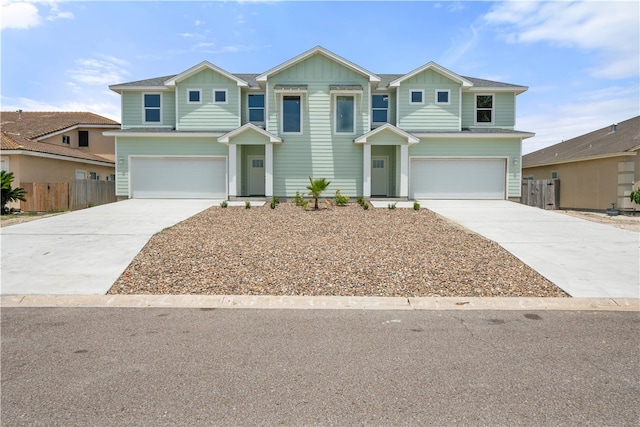 15501 Cruiser St Unit A, Corpus Christi, TX 78418 - view of front facade featuring a garage, concrete driveway, and board and batten siding