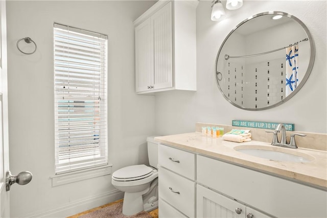 bathroom with vanity, curtained shower, and toilet