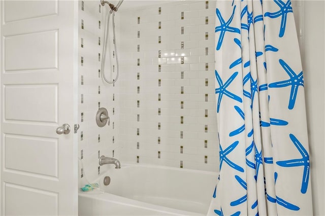 bathroom with shower / bath combo with shower curtain