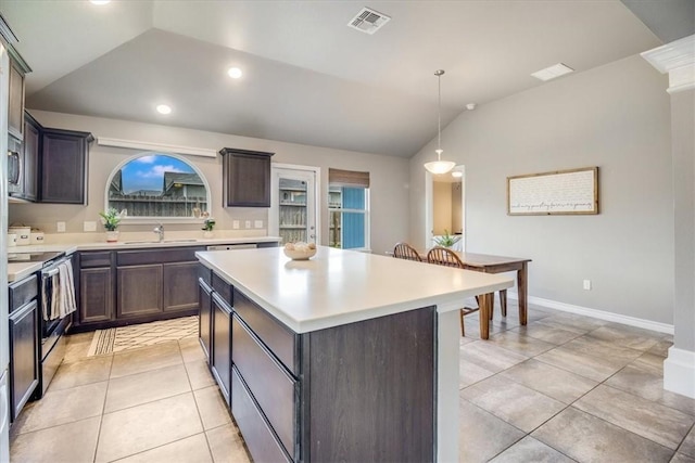 6753 Mikayla St, Corpus Christi, TX 78413 - kitchen featuring stainless steel electric stove, lofted ceiling, light countertops, a kitchen island, and dark brown cabinetry
