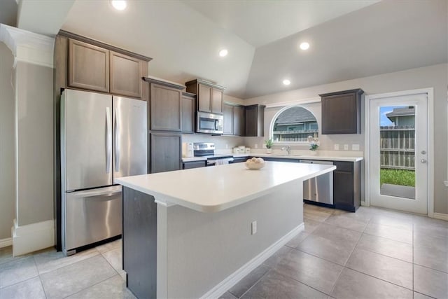 6753 Mikayla St, Corpus Christi, TX 78413 - kitchen with stainless steel appliances, a center island, light countertops, lofted ceiling, and light tile patterned flooring