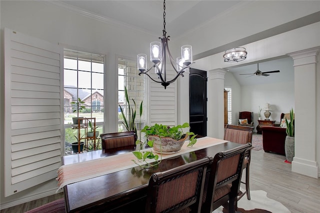 dining room with ornamental molding, ornate columns, light hardwood / wood-style floors, lofted ceiling, and ceiling fan