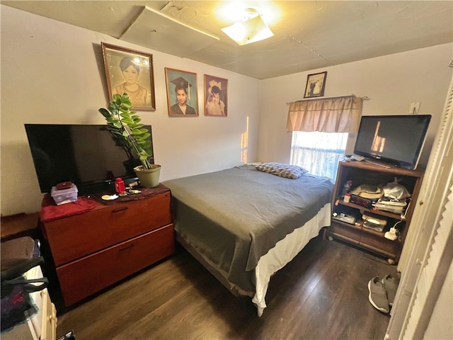 bedroom with dark wood-type flooring